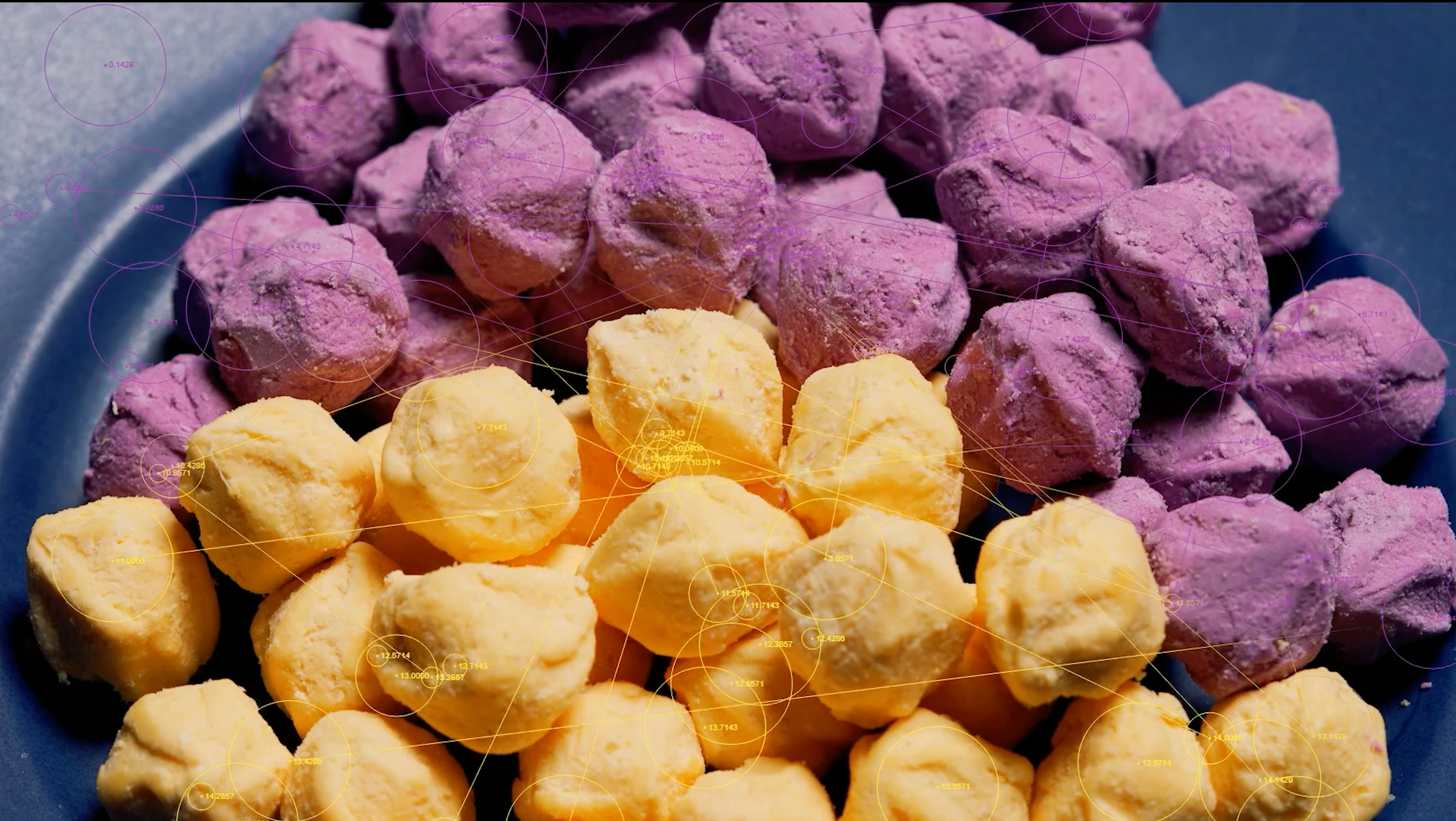 Frozen yellow and purple sweet potato balls close-up on plate.
